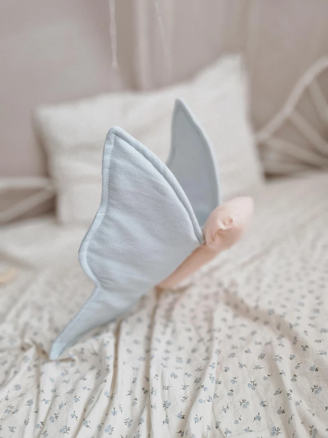 Butterfly Nursery Decoration, a colourful butterfly decoration sitting on a child's bed. 