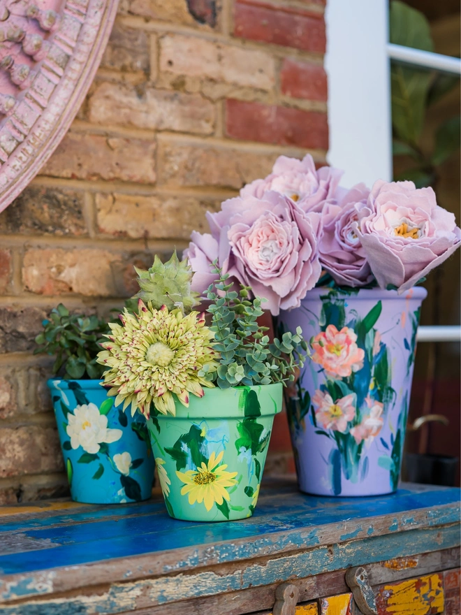 Hand painted floral plant pot, turquoise background with pale yellow peonies 