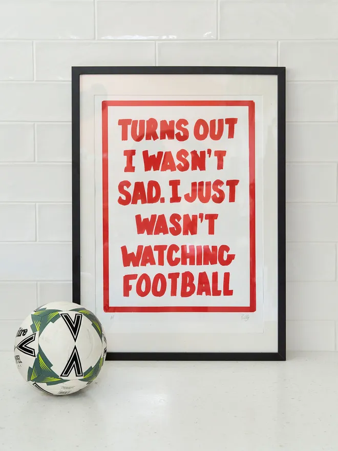 'Turns out I wasn't sad. I just wasn't watching football- print in red writing with a football next to it 