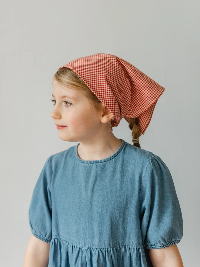 girl wearing her red gingham headscarf