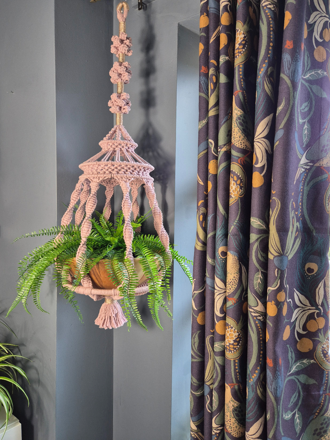 handmade luxurious macrame plant hanger featuring intricate knot designs, showcasing a solid wood bowl for your favourite plant to sit inside, hung elegantly in any room.