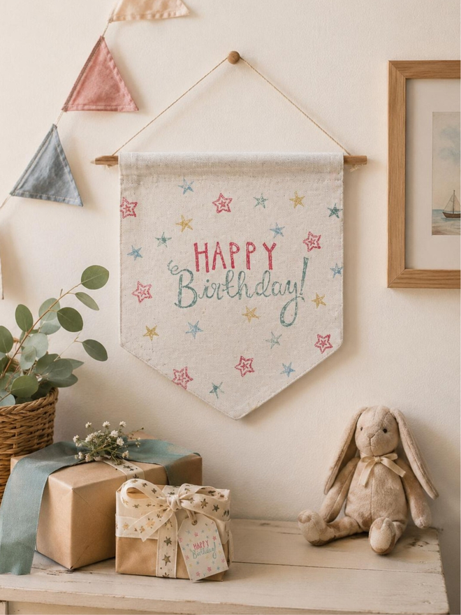 reusable birthday cotton wall hanging. a hanging wall banner with a happy birthday message and printed stars.
