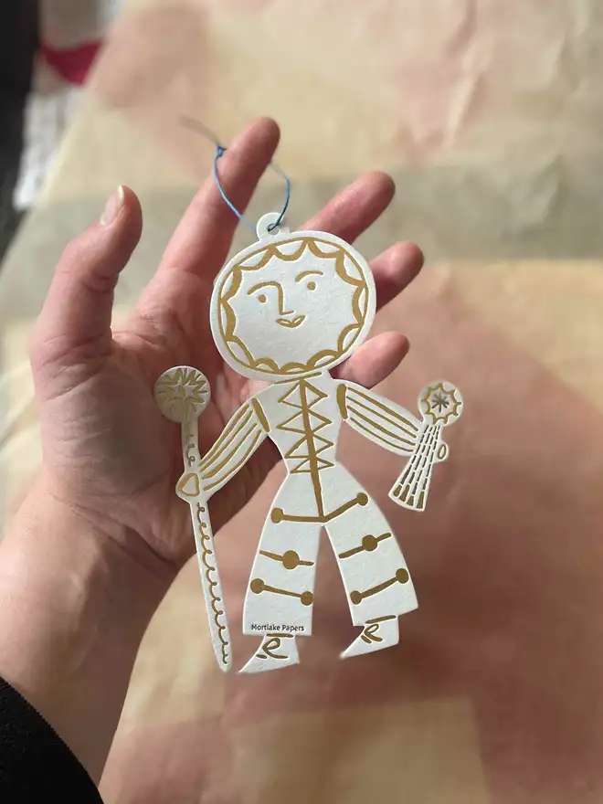 sun celestial letterpress decoration held in hand