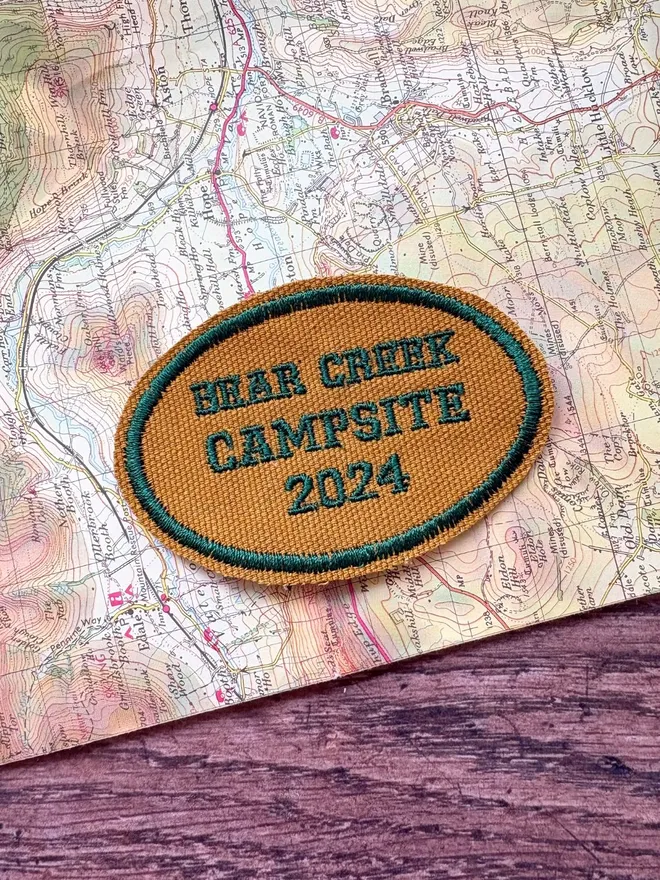 Custom location patch in navy and cream with the wording Ben Nevis laying on a vintage map