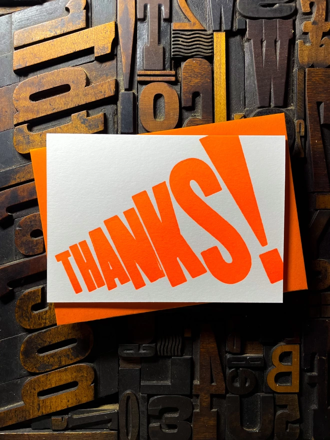 Thanks! A vibrant thank you typographic letterpress card with deep impression print using fluorescent orange, with a range of colourful envelopes. Slight print variations adding to the style anding to the charm of this handmade greeting card.