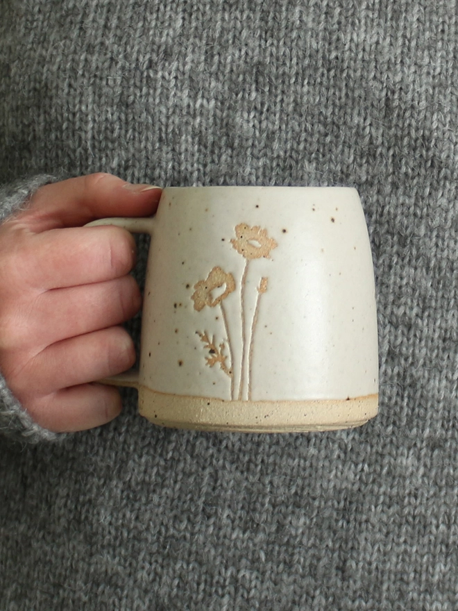 Hand holding Poppy mug