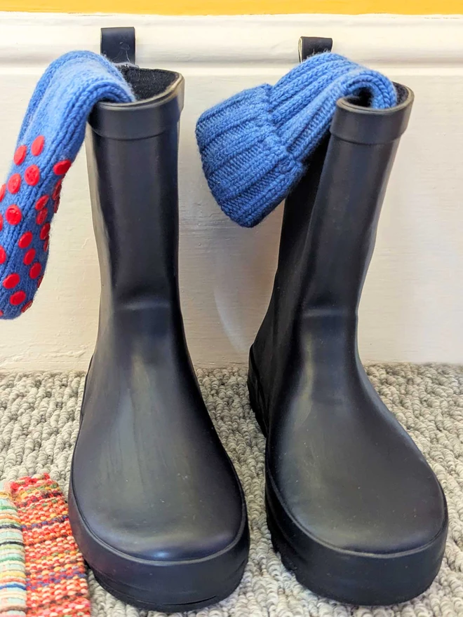Blue Kids Socks Displayed In Green Wellington Boots