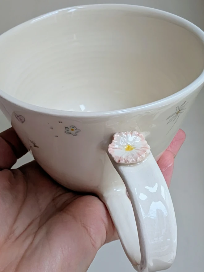handmade ceramic cup for mum with flowers, daisy hearts and tiny honey bee in white earthenware with pink highlights