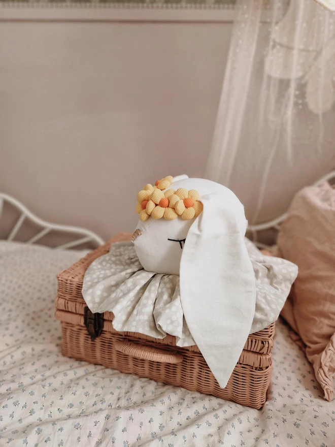 Rabbit Head Wall Mount, a cotton rabbit head wall decoration in a child's bedroom accompanied by other bedroom accessories. 
