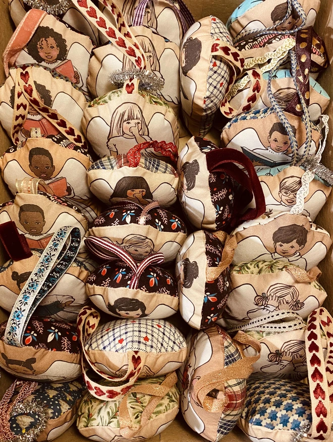 A collection of handmade hand sewn angel christmas tree decorations 