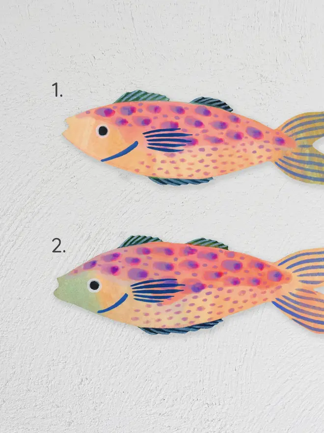 wooden fish wall decoration. wooden fish wall decorations hung on plain white wall and numbered for identification of designs.