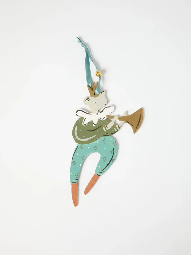 Mouse Herald Tree Dancer. a flat lay product shot of the mouse herald tree dancer hanging ornament in olive green and teal tones, on a plain white background. the mouse figure wears a gold crown, a ruffled white collar and a spotted olive jacket, playing a gold trumpet, with teal trousers ending in orange boots. the figure hangs from a teal ribbon with a small gold bell attached, giving the ornament a festive, folk-art charm.