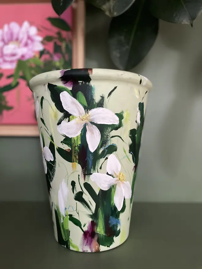 hand painted floral terracotta interior plant pot pale green background white clematis flowers