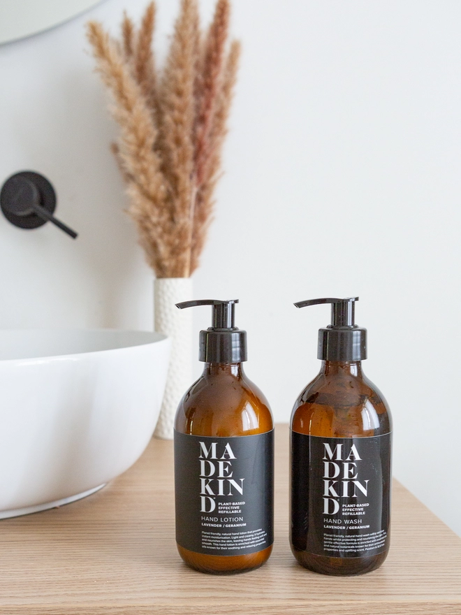 Hand wash and hand lotion in amber glass bottles on bathroom cabinet