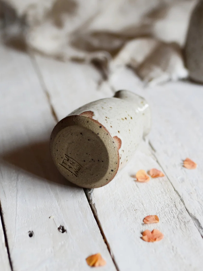 Wavy stoneware bud vase. A small stoneware bud vase with a wavy rim