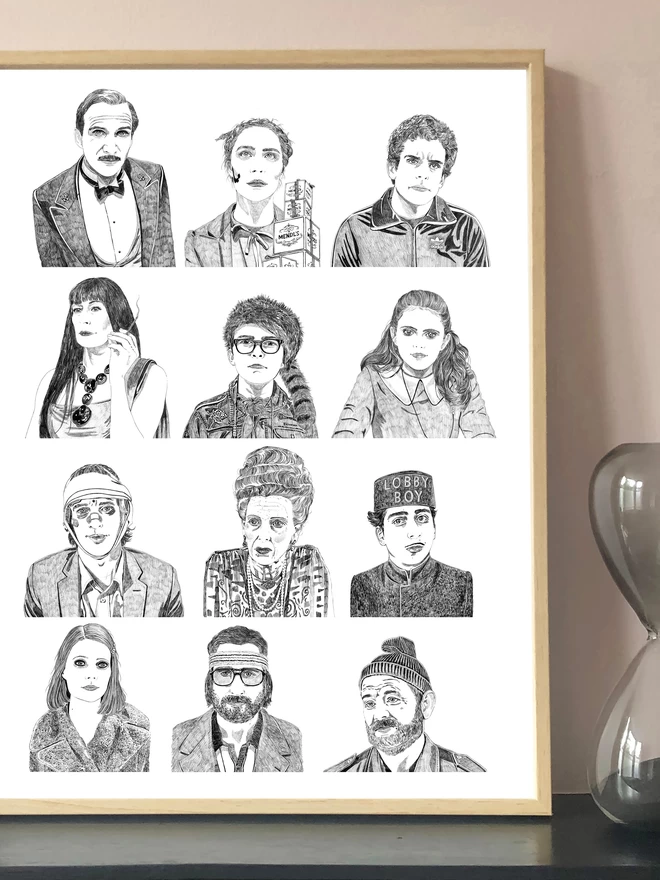 Art print of hand drawn portraits of Wes Anderson characters displayed in a frame