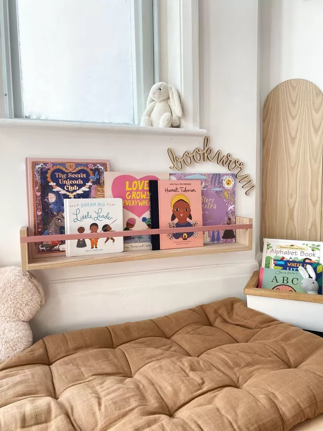 A book nook featuring children's book storage and kids decor
