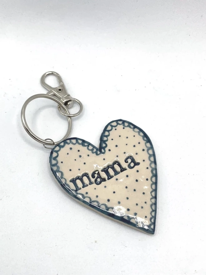 Mama Heart Ceramic Keyring, a blue keyring sitting on a plain white surface. 
