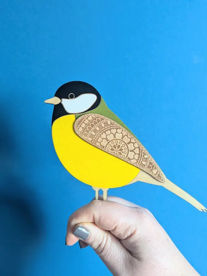 Standing Wooden Great Tit, yellow wooden bird decoration standing on a platform. 