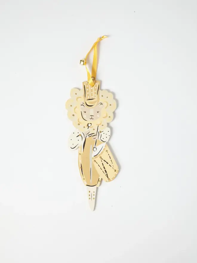 Lion Drummer Tree Dancer. wooden hanging lion drummer decoration with a gold top hat, cream mane, gold tunic and drum, yellow ribbon with a jingle bell, on a white background