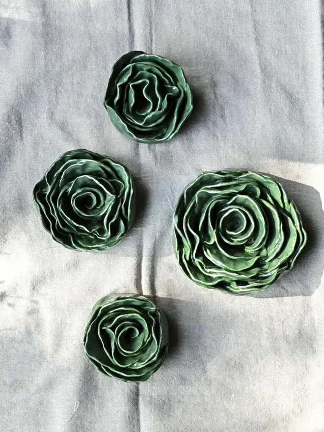 green ceramic rose sculptures