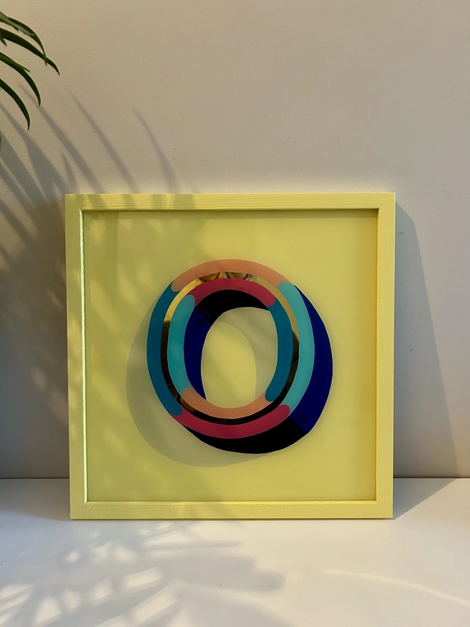 Gold leaf initial O Yellow checkered frame