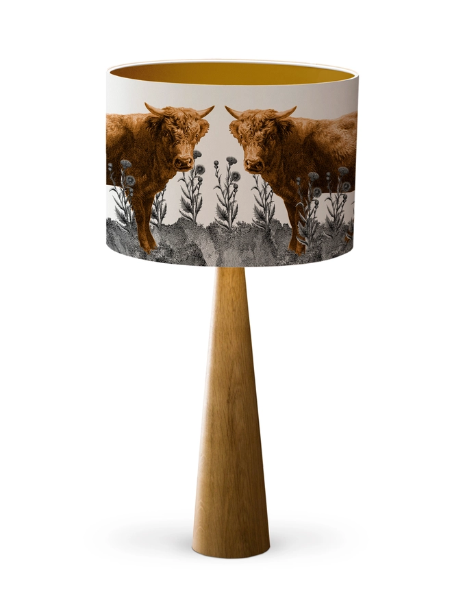 Lampshade of Highland Cow in a field of Scottish thistles