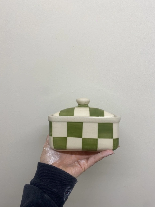  Checkered Green & Cream Handmade Ceramic Butter Dish, a green patterned butter dish held against a white backdrop. 