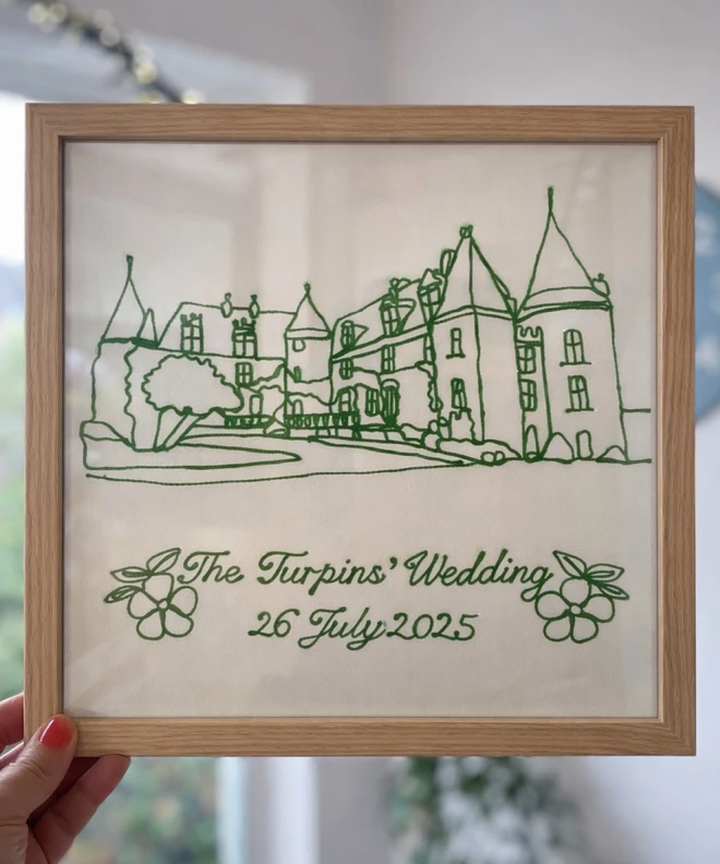 oak effect framed embroidered wedding venue keepsake a moss green embroidery of a wedding venue on cotton rag paper.