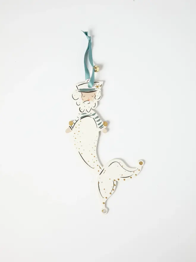 Merman Tree Dancer. a close-up flat lay shot of the merman tree dancer hanging ornament on a plain white background, showing the bearded figure's sailor hat, striped teal top and cream scale-patterned tail in fine detail. the tail curls into a jester-style pointed tip with gold and silver dot detailing, ending in orange-tipped points. the figure hangs from a teal ribbon with a small gold bell attached.
