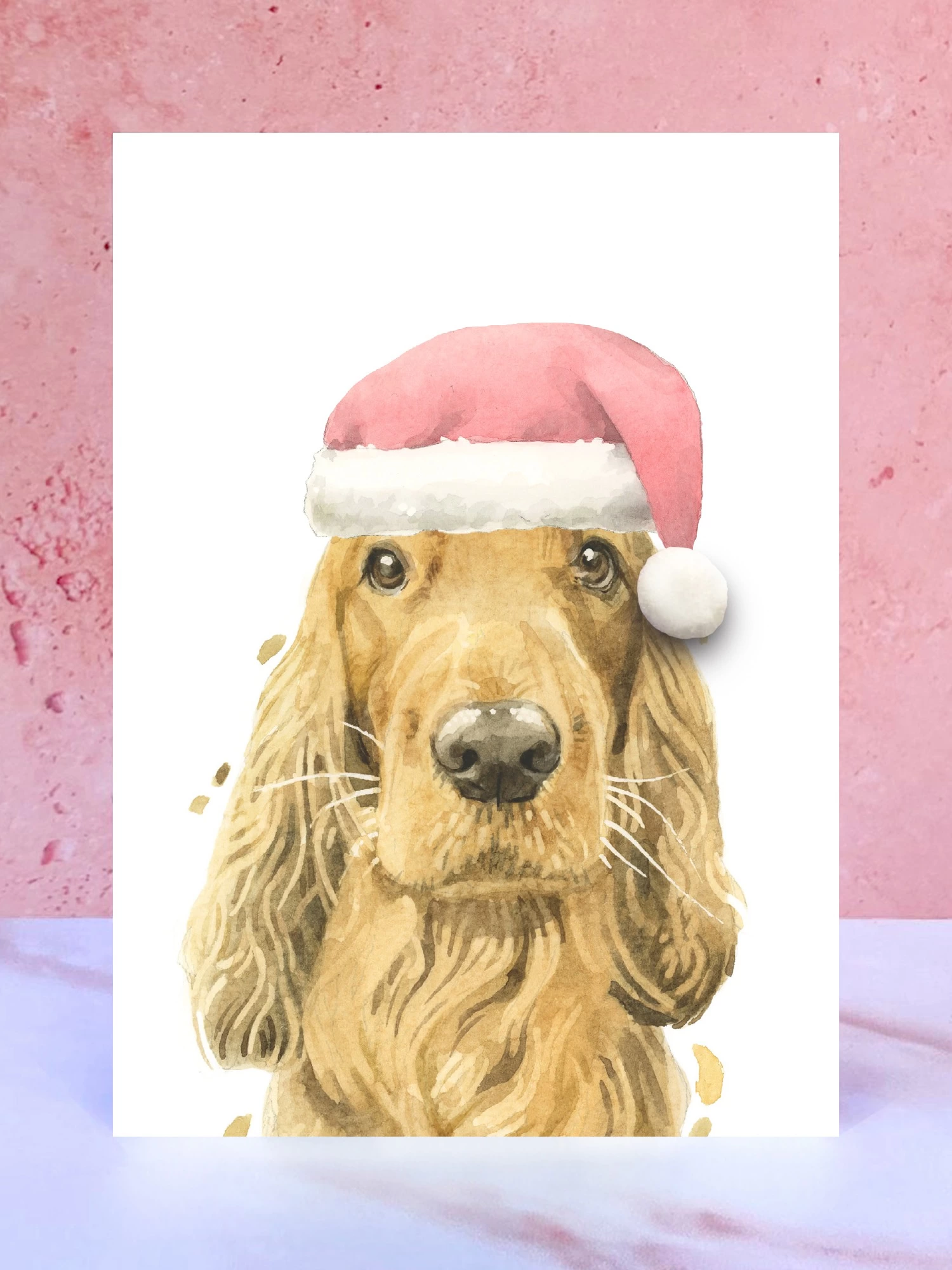 A Christmas card featuring a hand painted design of ginger cocker spaniel, stood upright on a marble surface. 