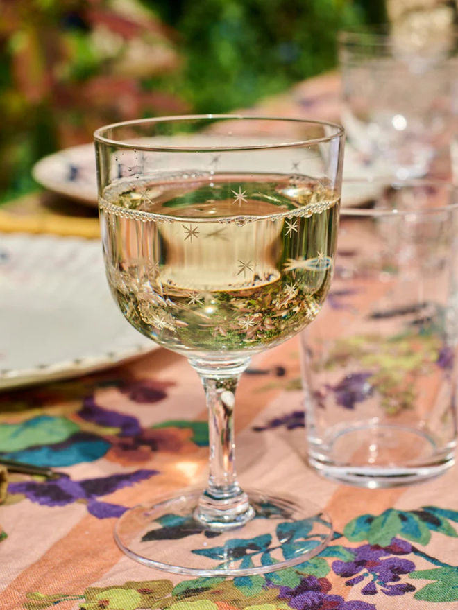 'daphne' engraved stars wine glass. a crystal wine glass with star detailing.