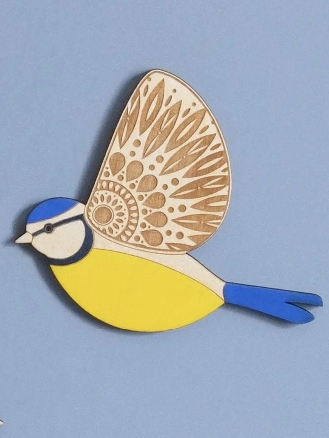 Folk Art Wooden Blue Tits (Set Of 3), wooden blue tit hung up on a wall, flying. 