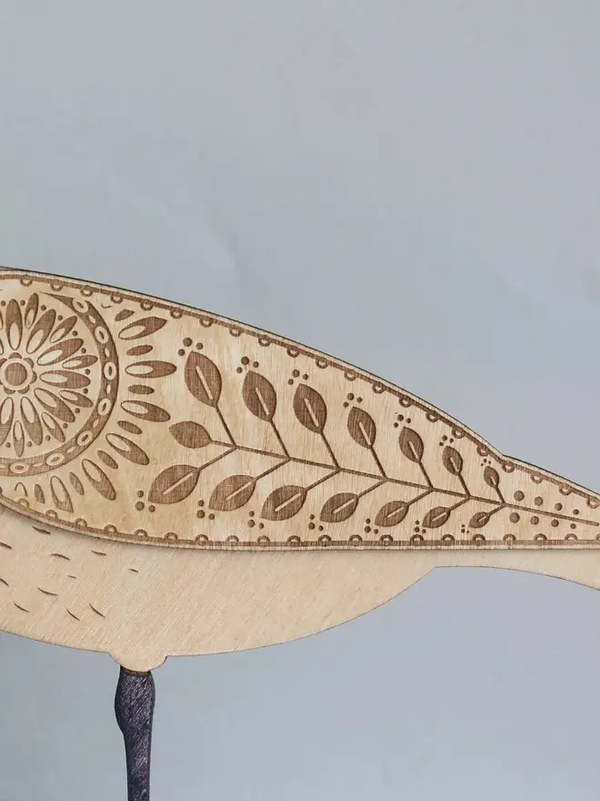 Standing Wooden Curlew, wooden bird decoration standing on a platform. 