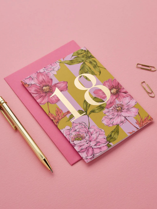 floral age milestone card. a pink floral 18th birthday card photographed against a pink background.