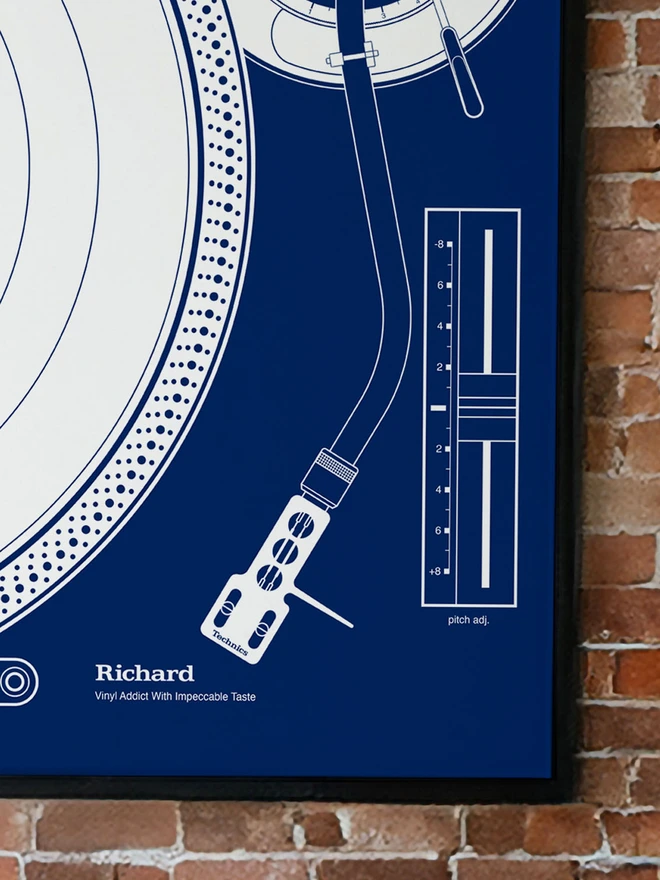 Framed giclée art print featuring a minimal, technical line illustration of a Technics SL-1200MK2 turntable in navy blue and white, showing the platter, tonearm, and pitch control. Personalised options shown.