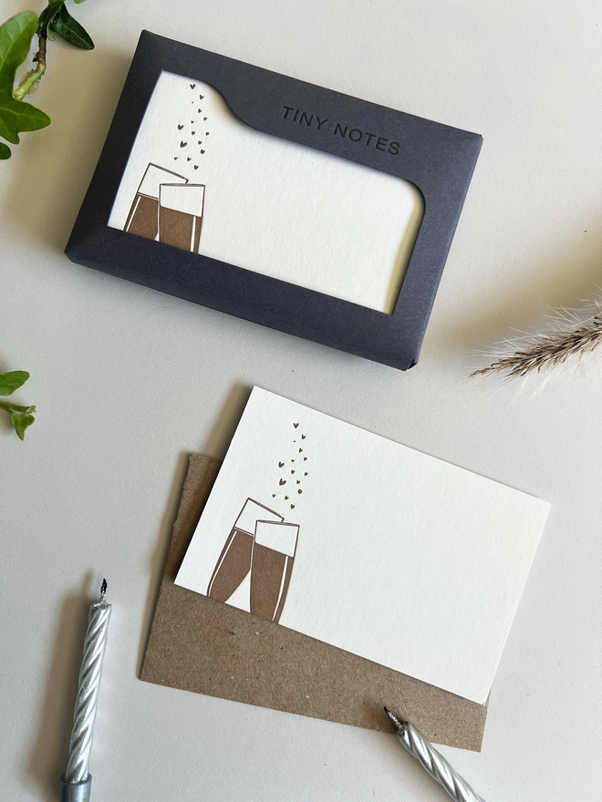 Tiny notes box with a card and envelope next to it.