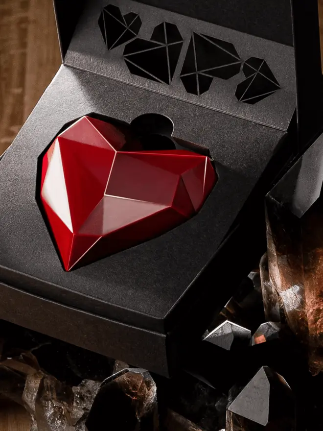 Red heart chocolate close up, shining like a jewel