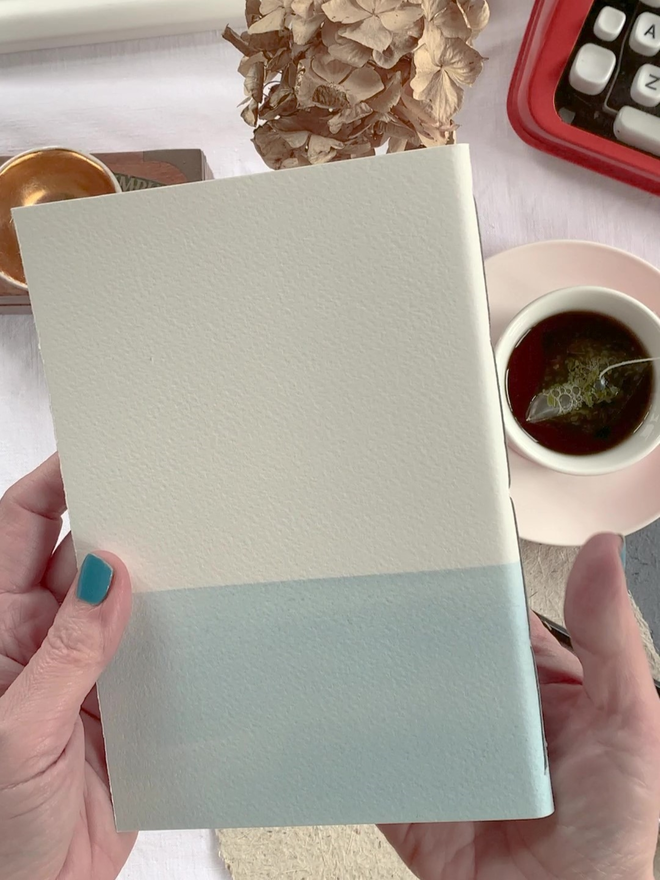 back of pale blue and white notebook