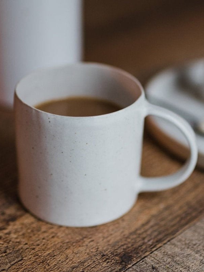 white handmade ceramic mug of tea lifestyle shot