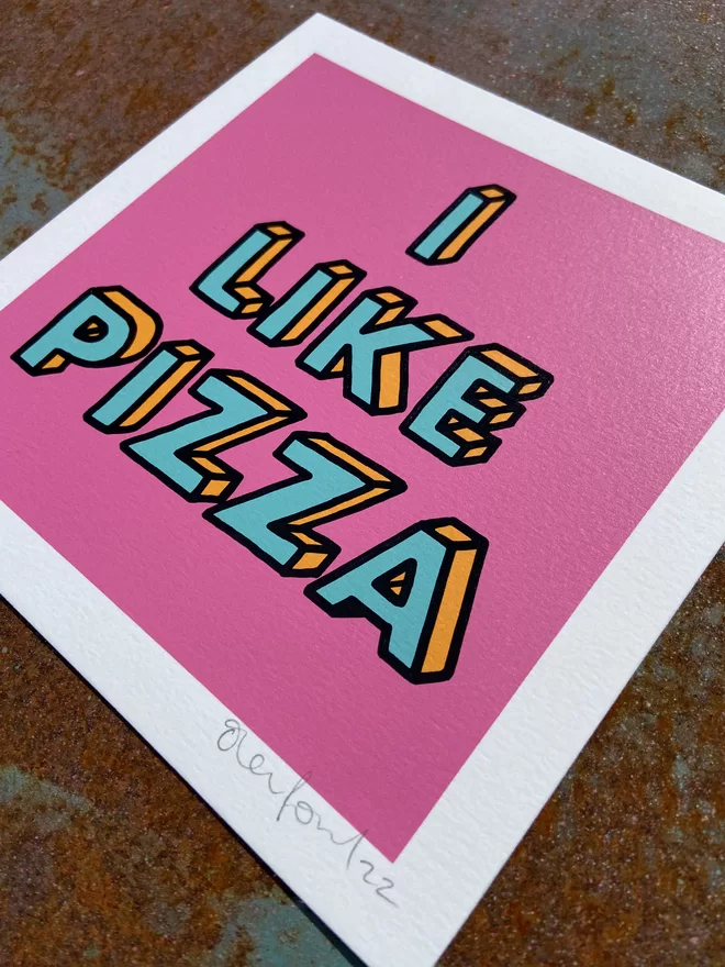 "I like Pizza" Mini Hand Pulled Screen Print square with pink background and the words i like pizza hand drawn and printed on top with black outline to the letters 