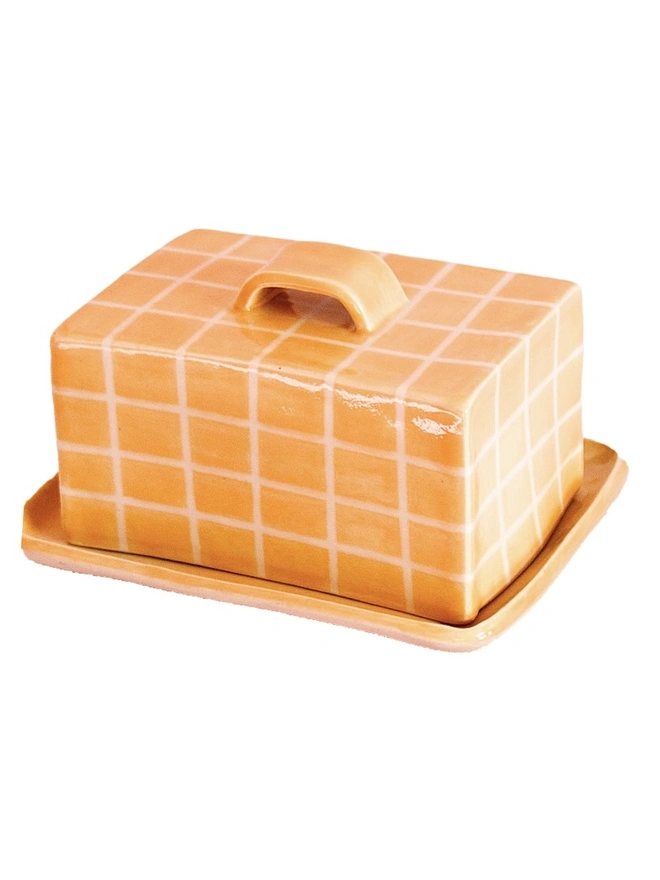 Grid Butter Dish, a colourful butter dish with a grid pattern sitting on a white tabletop surface. 