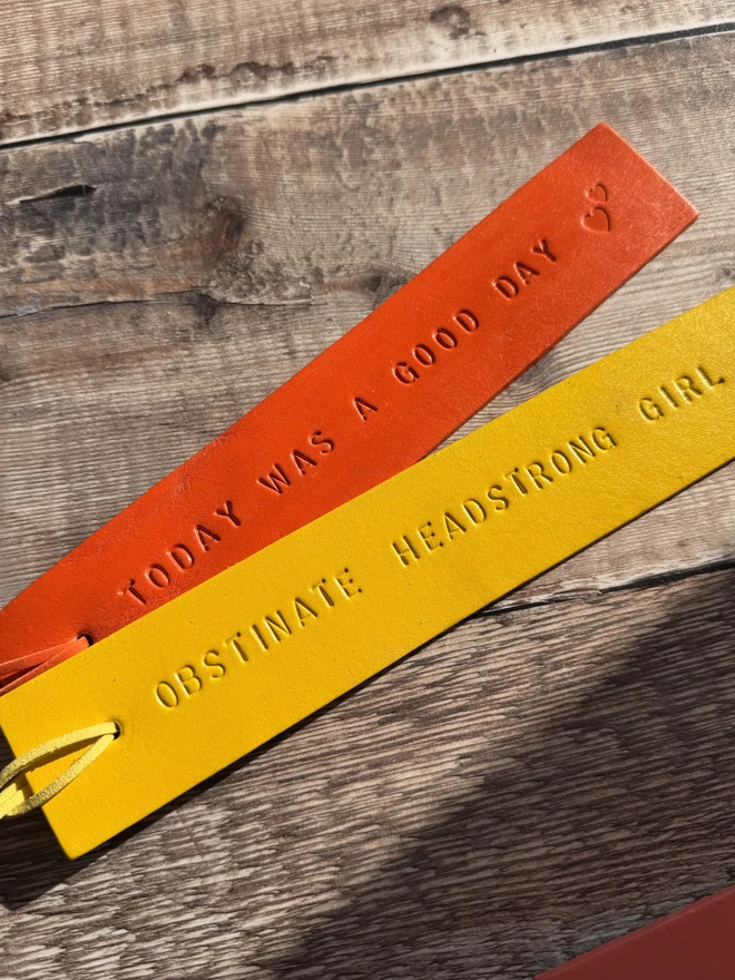 Colourful hand-painted leather bookmarks with embossed quotes, each featuring a leather tie. A stylish and durable accessory for book lovers, perfect as a personalised gift