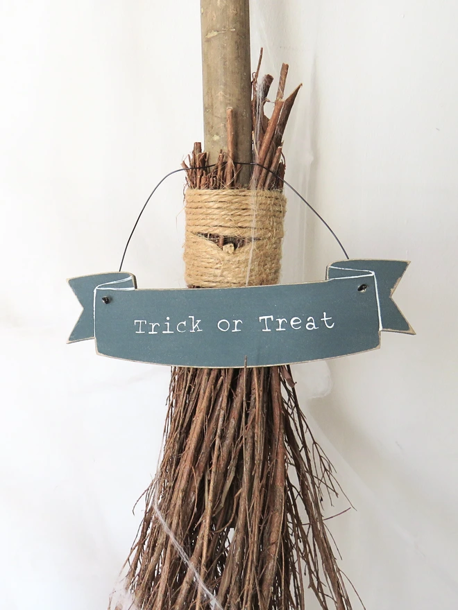 inky blue hand painted wooden banner decoration with trick or treat message