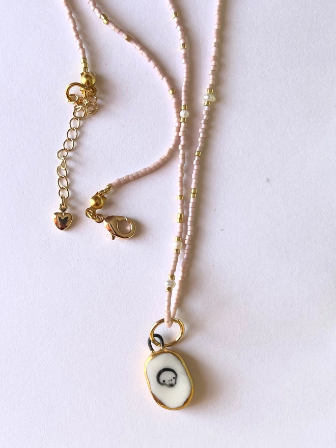 pink necklace with skull pendant