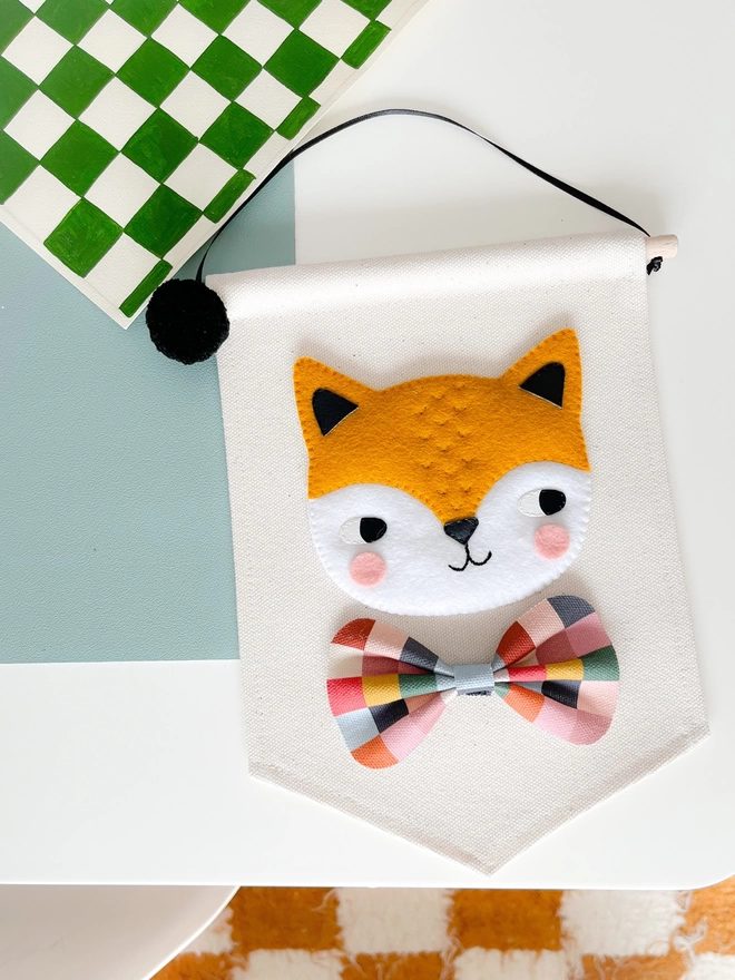 Hand sewn fox banner on a table