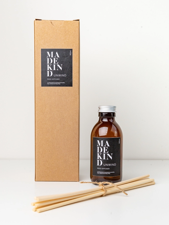 Room diffuser with essential oils in amber glass jar with reeds and packaging box