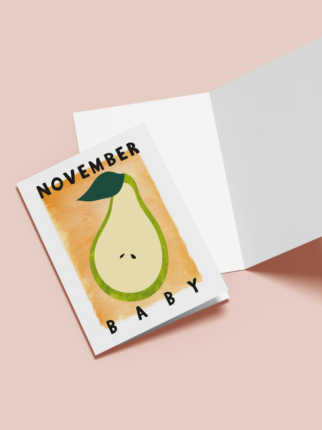 november baby illustrated card. an orange card with a pear in the center.