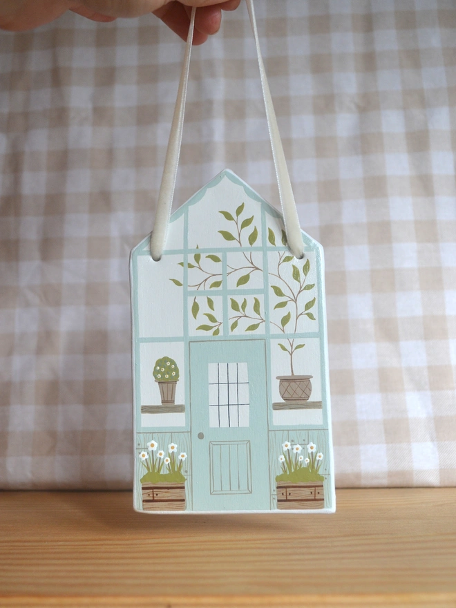 white hanging decoration with white and blue greenhouse design