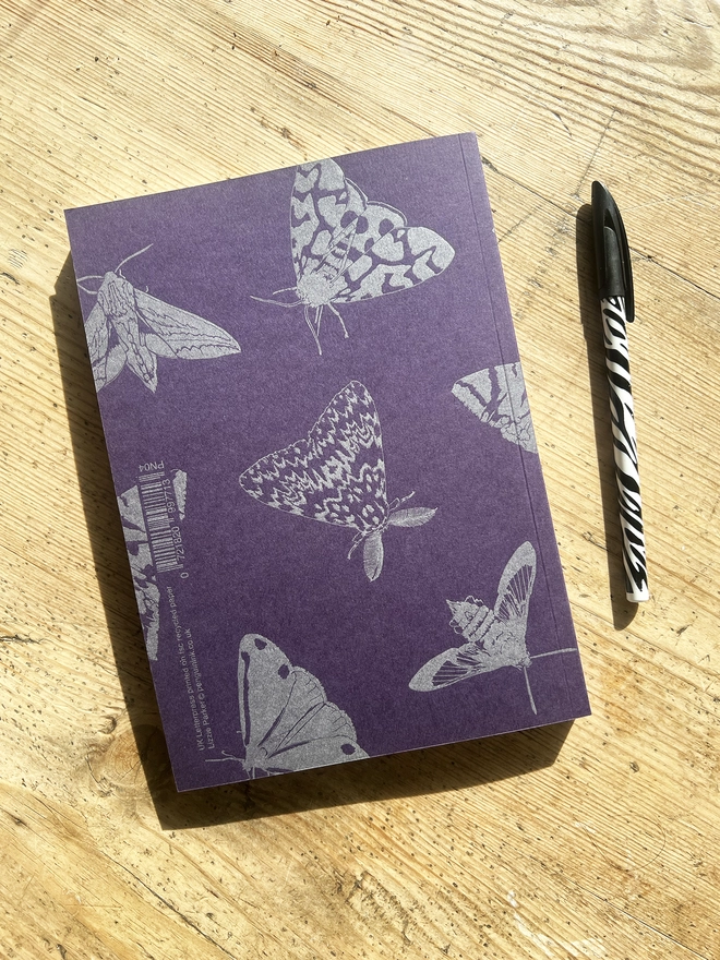 Back of the notebook with a pen next to it.